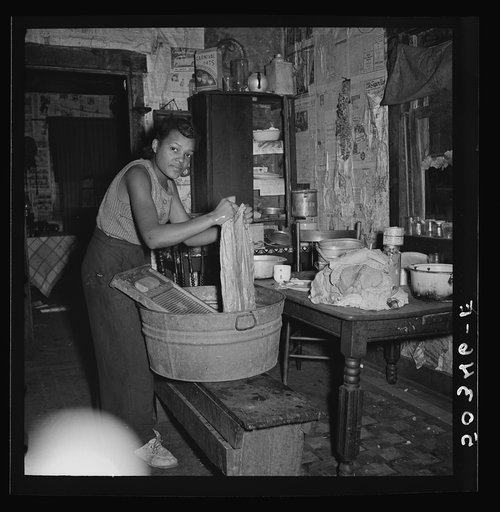 Coal miner's daughter doing the family wash. All the water must be carried from up the hill. Bertha Hill, West Virginia