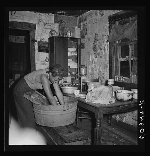 Untitled photo, possibly related to: Coal miner's daughter doing the family wash. All the water must be carried from up the hill. Bertha Hill, West Virginia