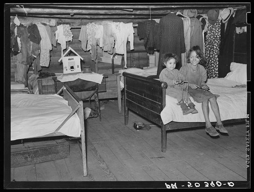 Untitled photo, possibly related to: Indian girl and her sister showing house she made. The entire one-room house she lives in is completely filled with beds for the large family. Near Pembroke Farms. Maxton, North Carolina