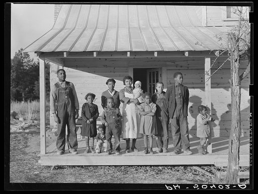 Negro family (rehabilitation clients) on porch of new home they are building near Raleigh, North Carolina