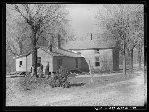Rear view of home being remodeled for rehabilitation client, showing new addition on left. Near Raleigh, North Carolina