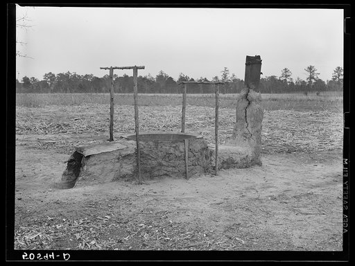 Mud and clay vat for cooking sorghum syrup in front yard of Indians home near Summerville, South Carolina