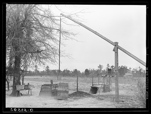 Well and mud vat for cooking sorghum syrup in front yard of Indians home near Summerville, South Carolina