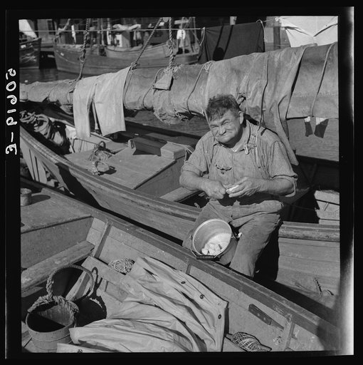 The cook on a fishing boat in Charleston, South Carolina, peeling potatoes for Christmas dinner