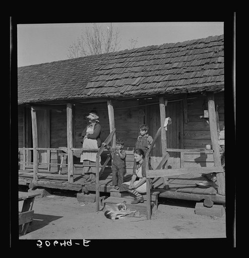 Indian (mixed breed) family on their front porch near Pembroke Farms. Maxton, North Carolina