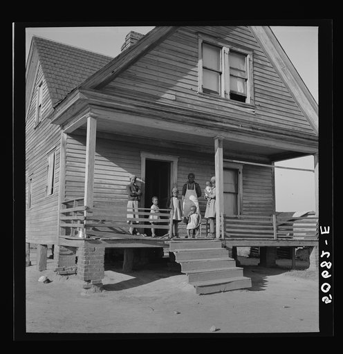 Untitled photo, possibly related to: Negro family on front porch of old home on badly eroded land near Wadesboro, North Carolina