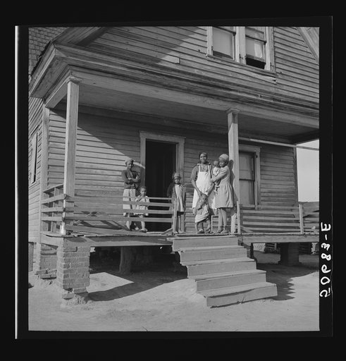 Negro family on front porch of old home on badly eroded land near Wadesboro, North Carolina