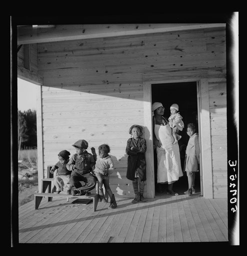 Family of rehabilitation client on front porch of new home near Raleigh, North Carolina
