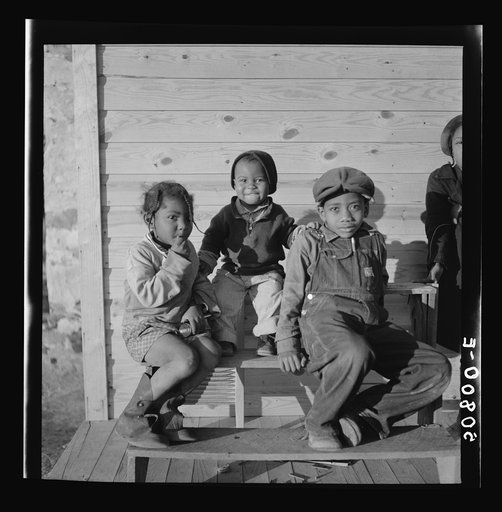 Children of rehabilitation client on front porch of new home near Raleigh, North Carolina