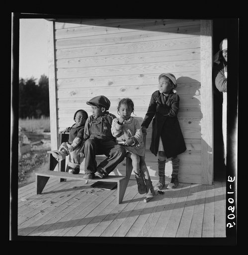 Children of rehabilitation client on front porch of new home near Raleigh, North Carolina
