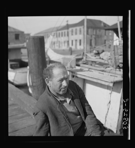 Fisherman on the dock, Charleston, South Carolina, on Christmas Day. He is from Boston and had been repairing motor on boat