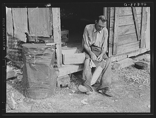 Migrant agricultural worker from Tennessee, formerly a railroad man, shelling dried beans he got in the fields for supper. Homestead, Florida