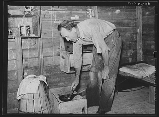 Untitled photo, possibly related to: Migrant agricultural worker from Tennessee, formerly a railroad man, eating dinner in his shack, an old tool house. Homestead, Florida