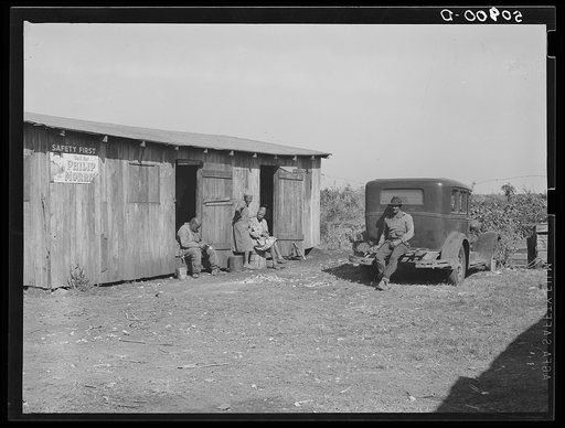 Negro migrant agricultural workers near Belle Glade, Florida. The car has a New Jersey license