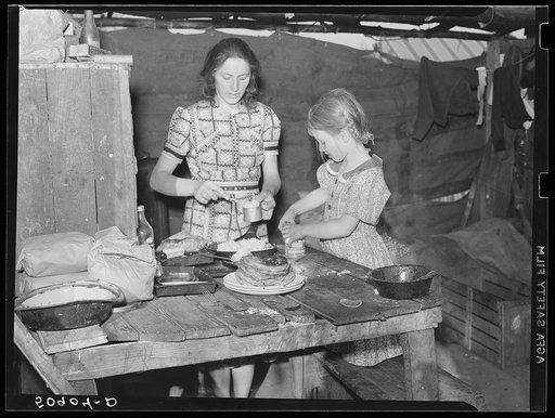 Woman migrant packinghouse worker and her oldest child fixing supper. She has three other children. Belle Glade, Florida