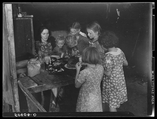Woman migrant packinghouse worker from Tennessee with four children and two relatives eating supper. Belle Glade, Florida