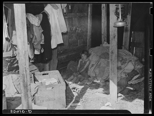 Migrant packinghouse worker's home, showing only bed for six people rolled up in the corner. They are from Tennessee. Parents must leave the children alone when both work. Belle Glade, Florida