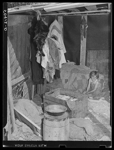 Migrant packinghouse worker's home, showing only bed for six people rolled up in the corner. They are from Tennessee. Parents must leave the children alone when both work. Belle Glade, Florida