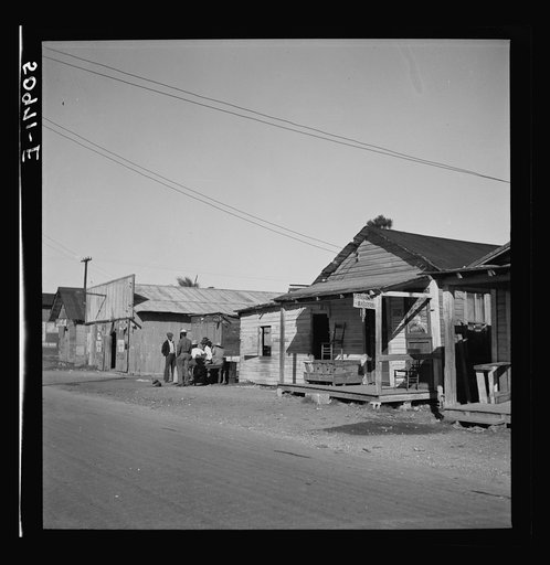 Main street, showing barber shop in Negro section. Homestead, Florida