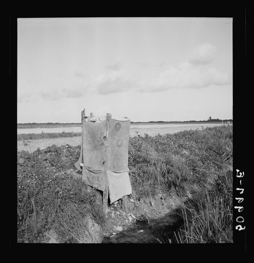 Untitled photo, possibly related to: Privy alongside irrigation and drainage ditch for agricultural workers. Homestead, Florida
