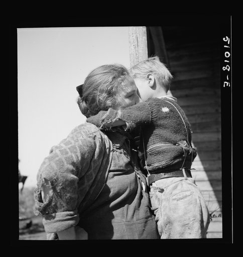 Untitled photo, possibly related to: Woman packinghouse worker from Tennessee trying to wash black muck, which causes an itchy rash and sores, off her youngest child. She has three others. The water came from a filthy canal nearby. Belle Glade, Florida