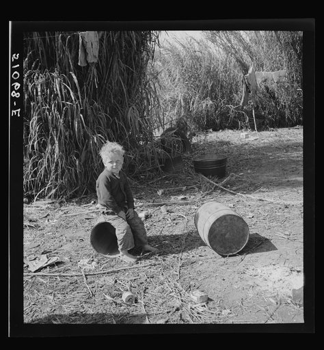 Untitled photo, possibly related to: Child of packinghouse workers from Tennessee, his face covered with black muck which causes an itchy rash. Belle Glade, Florida