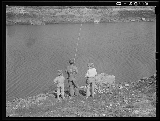 Migrant packinghouse workers' children fishing in canal near Belle Glade, Florida