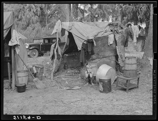 Migrant packinghouse workers living quarters. Just enough land to set up camp rents for five dollars per month. They have to clear it themselves. No water, lights, or sanitary facilities. Near Canal Point, Florida