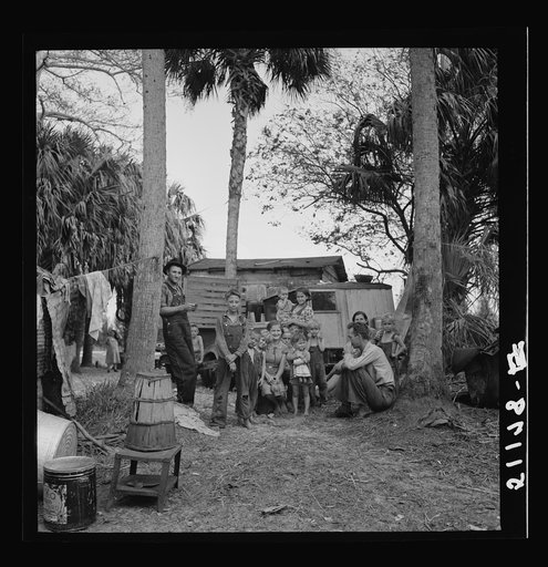 Migrant laborers' camp near Canal Point, Florida. In foreground is a bean hamper which they use to sit on and they call a "muck rocker." Some of them are from Missouri and Arkansas