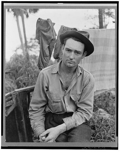 A migrant laborer waiting for work in one of the packing houses near Canal Point, Florida