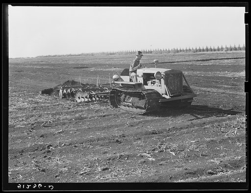 Tractor-driven disc plough and harrow used in preparing large acres of flat muck lands on many Florida farms around Lake Okeechobee and Clewiston, Florida