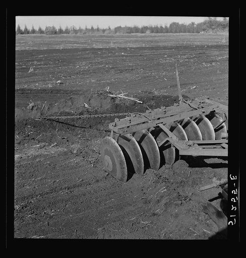 Untitled photo, possibly related to: Tractor-driven disc gang plough used on large tracts of land before planting sugarcane. USSC (United States Sugar Corporation). Clewiston, Florida