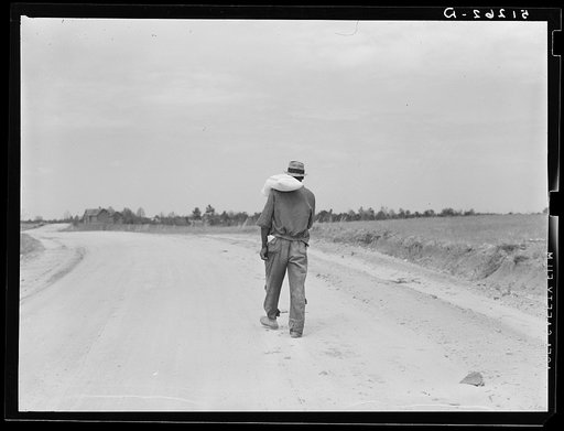 Colored tenant farmer carrying home a sack of flour which he calls "heaven dust." Greene County, Georgia