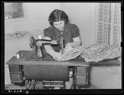 Mrs. Helms making dress. She does all her family sewing on new machine. FSA (Farm Security Administration) client. Coffee County, Alabama