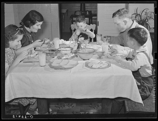 Helms family at dinner which consists of roast beef (home canned), turnip greens, potatoes, biscuits, corn bread, butter, milk, peaches, and cake. Coffee County, Alabama