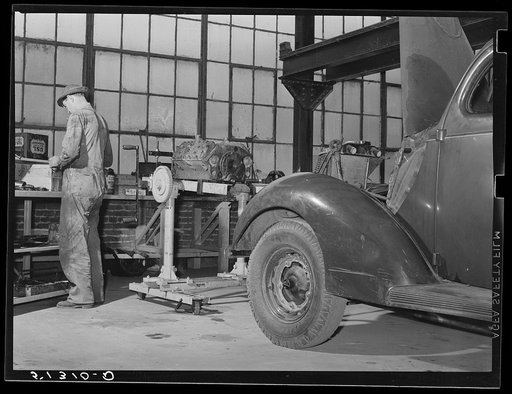 Repairing automobile motor. FSA (Farm Security Administration) warehouse depot. Atlanta, Georgia