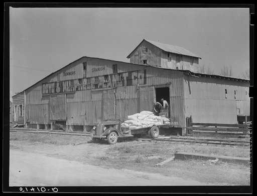 Loading truck with feed and fertilizer. Enterprise, Coffee County, Alabama