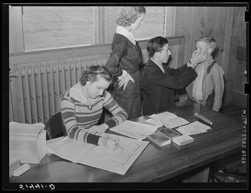 Doctor and nurse (Miss Teal) giving examination and treatment for hookworm to one of children in Goodman School health room. Coffee County, Alabama