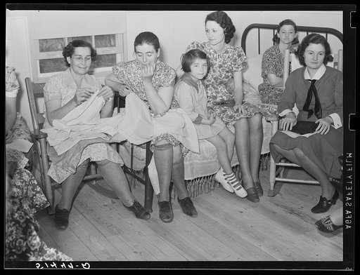 At a meeting of the Clark Hill Club, conducted by Miss Velma Patterson, vocational field worker from Elba, at the home of FSA (Farm Security Administration) project family, J.A. Veasy. The women discuss materials for clothing and curtains. Coffee County, Alabama