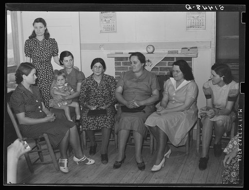 At a meeting of the Clark Hill Club, conducted by Miss Velma Patterson, vocational field worker from Elba, at the home of FSA (Farm Security Administration) project family, J.A. Veasy. The women discuss materials for clothing and curtains. Coffee County, Alabama