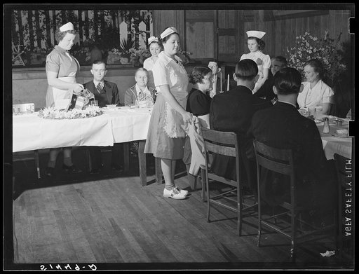 In the auditorium of the Mount Zion School, the Chamber of Commerce of a nearby town is being served dinner by home economics class. Coffee County, Alabama