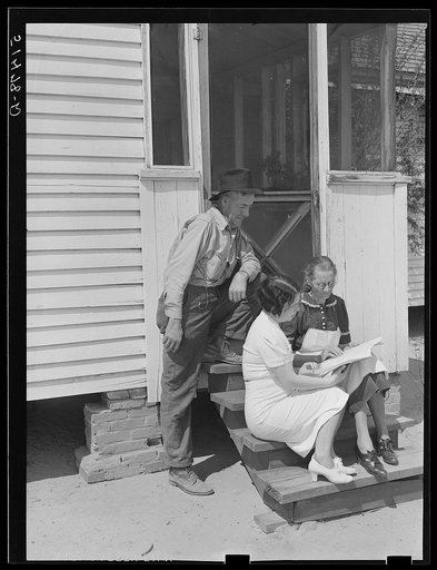 Home economist, Miss Maddox, discussing record book with Mr. And Mrs. Watkins. Coffee County, Alabama