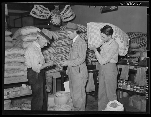 Farmer buying supplies on Saturday at farmers' exchange. Enterprise, Coffee County, Alabama