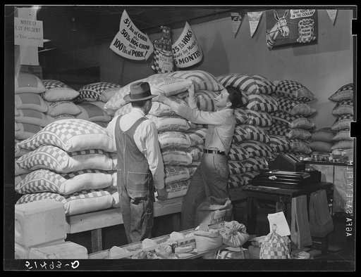 Farmer buying supplies on Saturday at farmers' exchange. Enterprise, Coffee County, Alabama