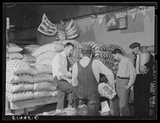Farmer buying supplies on Saturday at farmers' exchange. Enterprise, Coffee County, Alabama