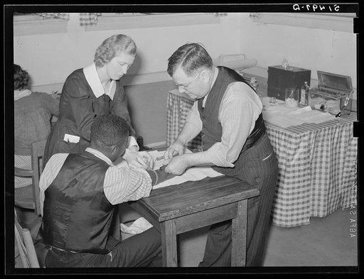 Miss Teal, nurse, and doctor W.R. Stanley giving treatment in venereal disease clinic. Enterprise, Coffee County, Alabama
