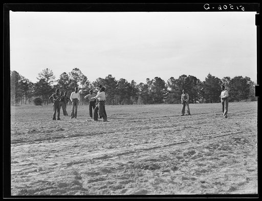 Untitled photo, possibly related to: Watching a Saturday afternoon ballgame (the first one). It has been very difficult to start recreational activities because of objections of old preacher. Gee's Bend, Alabama
