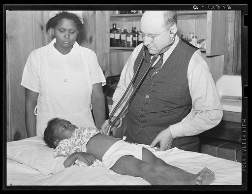Nurse Shamburg and Dr. Dixon (R.E.) examining Susanna Pettway, whose father, Clement Pettway, has been ill for several years with tuberculosis.  Gee's Bend, Alabama