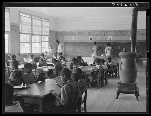First grade, showing extremes in ages of pupils. Oldest boy standing is just learning to read. Gee's Bend, Alabama