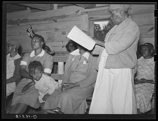 Star pupil, eighty-two years old, reading her lesson in adult class. Gee's Bend, Alabama